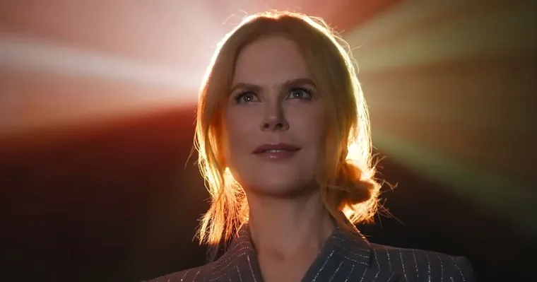 A frame from the AMC spot: Nicole Kidman looking up, lit from behind by the beam of the projector.